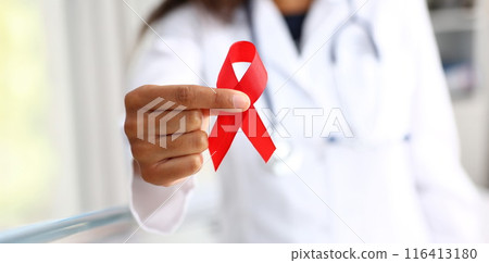 Black woman doctor holding a red ribbon 116413180