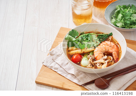 A hearty spicy soup made with glass noodles and topped with shrimp and other ingredients. A hearty spicy soup made with glass noodles and topped with shrimp and other ingredients. 116413198