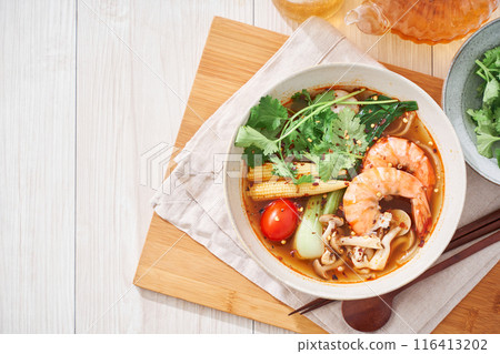 A hearty spicy soup made with glass noodles and topped with shrimp and other ingredients. A hearty spicy soup made with glass noodles and topped with shrimp and other ingredients. 116413202