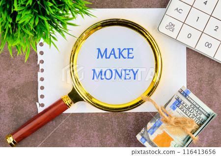 Business and Make Money concept. Copy space. Make Money symbol through a magnifying glass in a composition with American dollars, a calculator and a plant Business and Make Money concept. Copy space. Make Money symbol through a magnifying glass in a composition with American dollars, a calculator and a plant 116413656