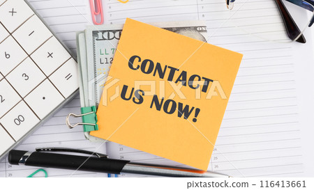 Copy space. Contact us now words written on a yellow sticker next to American hundred dollar bills, a calculator, a pen on a white background Copy space. Contact us now words written on a yellow sticker next to American hundred dollar bills, a calculator, a pen on a white background 116413661