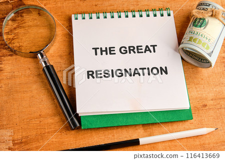 The words THE GREAT RESIGNATION in a notebook in a composition with a magnifying glass, dollars and a pencil The words THE GREAT RESIGNATION in a notebook in a composition with a magnifying glass, dollars and a pencil 116413669