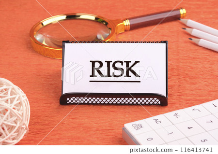 Risk management concept. RISK word written on a white card on a black stand 116413741
