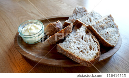 wholewheat sourdough Bread appetizer on wood plate served with butter wholewheat sourdough Bread appetizer on wood plate served with butter 116414515