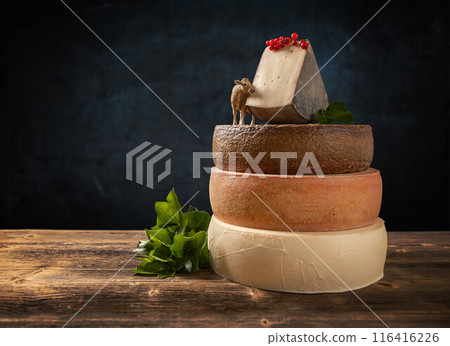 Cheesemaker showing a selection of aged cheeses 116416226