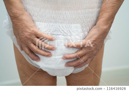 Asian elderly woman wearing diaper for loss of bladder urinary incontinence control. 116416926