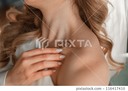 without a face. wedding rings on the bride's collarbone. without a face. wedding rings on the bride's collarbone. 116417410