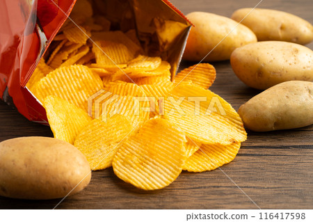 Potato chips fried snack fast food in open bag. 116417598
