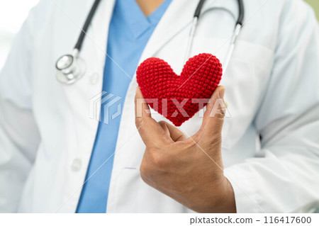 Doctor holding a red heart in hospital, heart Attack. 116417600