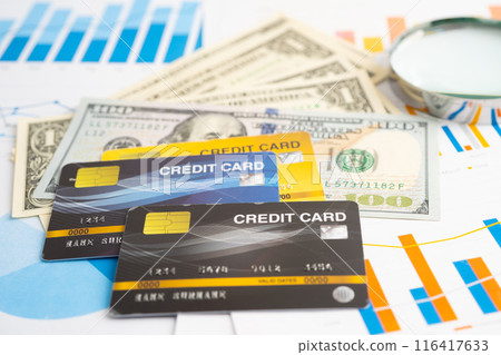 Credit card with US dollar banknotes on graph. Finance business and trading. Credit card with US dollar banknotes on graph. Finance business and trading. 116417633