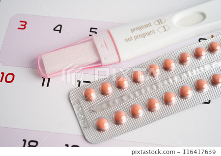 Pregnancy test and birth control pills on calendar, contraception health and medicine. Pregnancy test and birth control pills on calendar, contraception health and medicine. 116417639