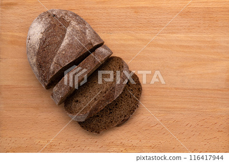 rye bread cut into slices on wooden background, top view rye bread cut into slices on wooden background, top view 116417944