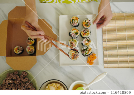 Woman Packing Homemade Kimbap In Lunchbox Woman Packing Homemade Kimbap In Lunchbox 116418809