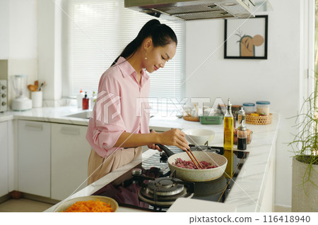 Housewife Preparing Dinner In The Kitchen Housewife Preparing Dinner In The Kitchen 116418940