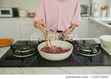 Housewife Frying Meat For Dinner Housewife Frying Meat For Dinner 116418942