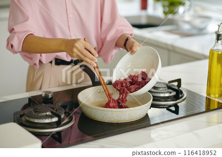 Woman Frying Meat On Pan 116418952