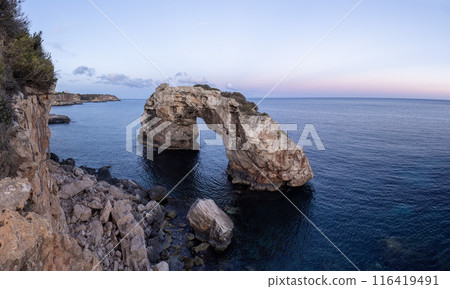 Mallorca, Spain, beautiful coastline with view of the rock arch Es Pontas , Mediterranean Sea, Balearic Islands. Mallorca, Spain, beautiful coastline with view of the rock arch Es Pontas , Mediterranean Sea, Balearic Islands. 116419491