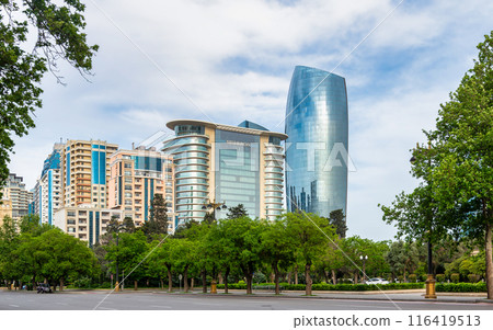 A view of modern high-rise buildings in Baku, Azerbaijan, including the JW Marriott Absheron hotel with a row of trees A view of modern high-rise buildings in Baku, Azerbaijan, including the JW Marriott Absheron hotel with a row of trees 116419513