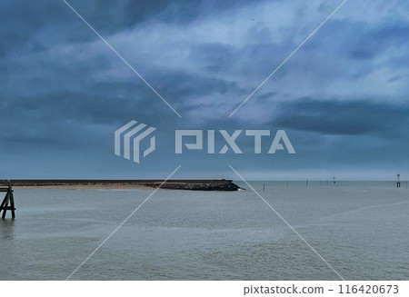 Lighthouse at the end of the pier on a stormy day in Normandy, France in a cloudy day. Lighthouse at the end of the pier on a stormy day in Normandy, France in a cloudy day. 116420673
