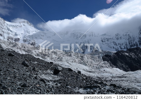 Tranquil Lake With Lush Green Forest, Snow-Capped Mountain, Blue Sky And White Clouds 116420812