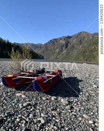 The red boat is on the shore of the mountain river Katun in the Altai Republic, Russia 116420835