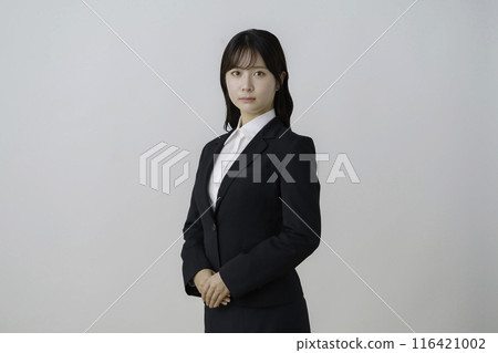 Portrait of a young woman in a suit on a white background Portrait of a young woman in a suit on a white background 116421002