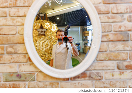 Photographer taking selfie photo in round mirror. Photographer taking selfie photo in round mirror. 116421274