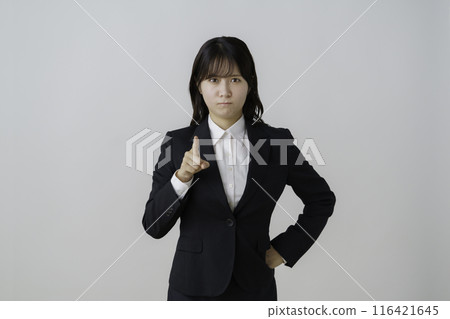 Portrait of an angry young woman in a suit on a white background 116421645