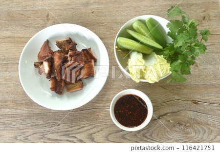 gilled slice pork bone on plate with vegetable dipping spicy chili tamarind sauce gilled slice pork bone on plate with vegetable dipping spicy chili tamarind sauce 116421751