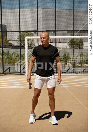 Portrait of sports trainer and handsome athlete man on outdoor sports ground. Close up. Copy space. Outdoors. Workout open air on urban background. Crossfit training. Portrait of sports trainer and handsome athlete man on outdoor sports ground. Close up. Copy space. Outdoors. Workout open air on urban background. Crossfit training. 116422467