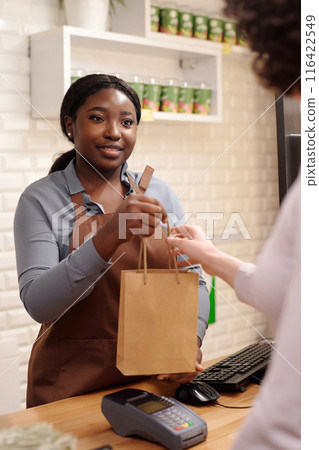 Passing paperbag with skincare products Passing paperbag with skincare products 116422549