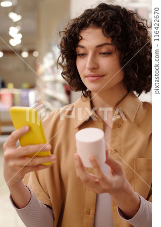 Brunette woman with jar of facial cream Brunette woman with jar of facial cream 116422670