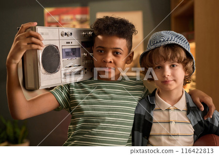 Portrait of Boys Holding Boombox in Living Room Portrait of Boys Holding Boombox in Living Room 116422813