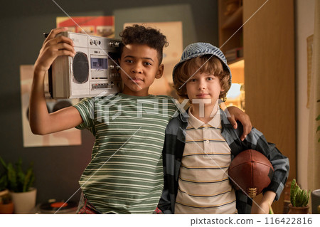 Portrait of Boys Holding Boombox and Football in Living Room Portrait of Boys Holding Boombox and Football in Living Room 116422816