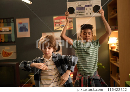 Boys Dancing and Holding Boombox in Cozy Living Room 116422822