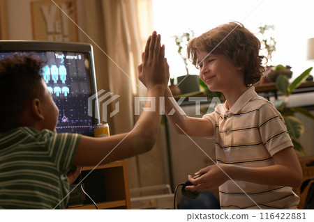 Boys High-Fiving After Winning Video Game 116422881