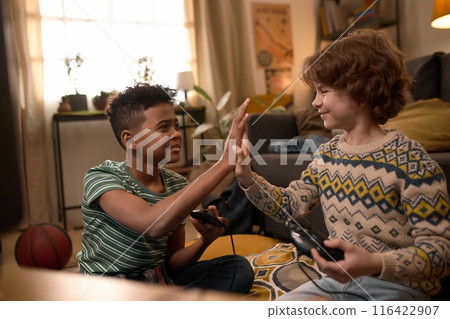 Boys Celebrating Video Game Win with High Five Boys Celebrating Video Game Win with High Five 116422907