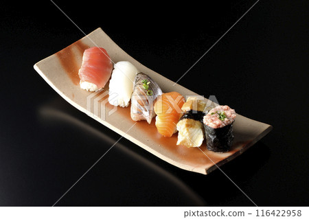 Nigiri sushi set photographed against a black background Nigiri sushi set photographed against a black background 116422958