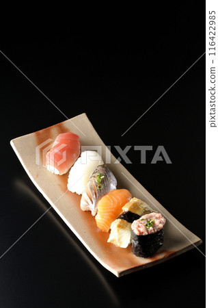 Nigiri sushi set photographed against a black background Nigiri sushi set photographed against a black background 116422985