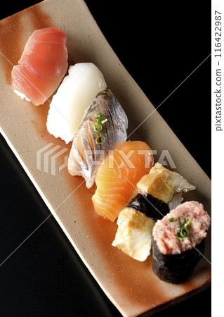 Nigiri sushi set photographed against a black background Nigiri sushi set photographed against a black background 116422987