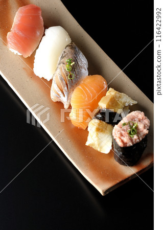 Nigiri sushi set photographed against a black background Nigiri sushi set photographed against a black background 116422992