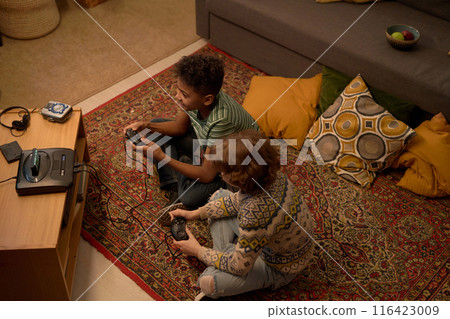 Two Multiethnic Boys Enjoying Retro Video Game Session Two Multiethnic Boys Enjoying Retro Video Game Session 116423009