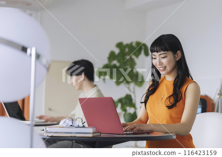 A young woman working on a laptop A young woman working on a laptop 116423159