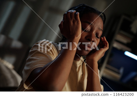 Crying young woman touching her head Crying young woman touching her head 116423200