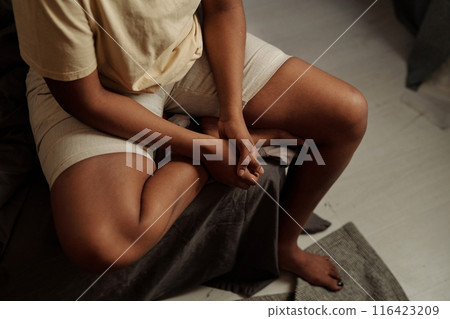 Legs and hands of depressed woman 116423209