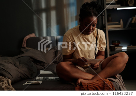 Woman looking at picture of sweetheart Woman looking at picture of sweetheart 116423257