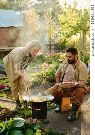 Frying potatoes for dinner in the garden 116423391