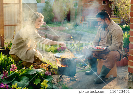 Frying chopped potatoes on hot pan 116423401