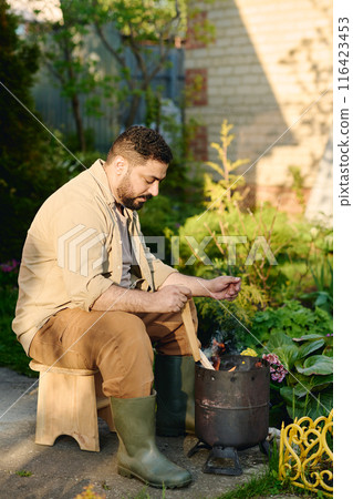 Farmer burning weeds and other garbage Farmer burning weeds and other garbage 116423453