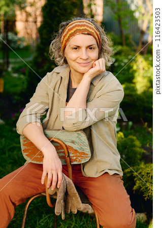 Restful female gardener in workwear Restful female gardener in workwear 116423503